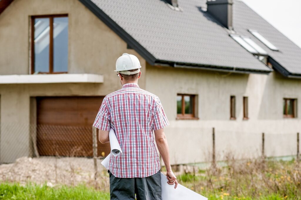 Image of a home builder facing a house