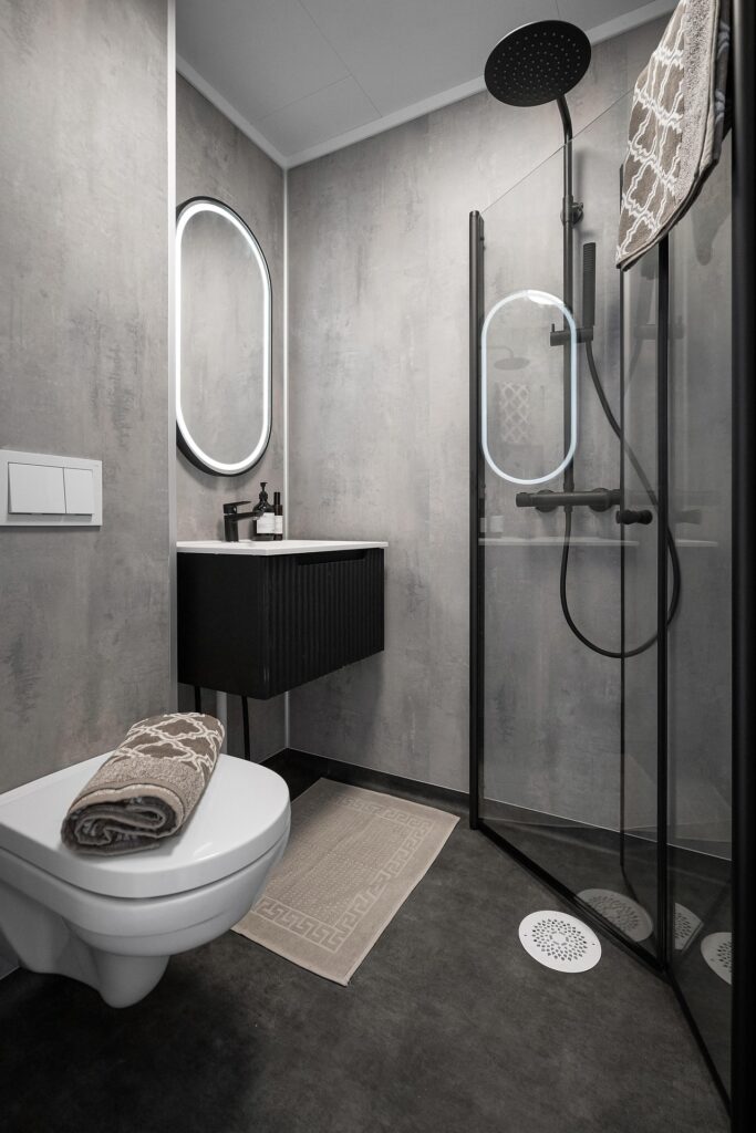 Modern luxury bathroom designed with sleek gray walls and a minimalist floating vanity