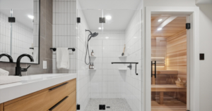 A modern bathroom remodel featuring a walk-in shower and enclosed sauna.