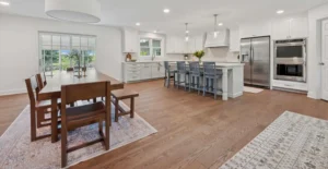 Open-concept kitchen/dining room space with adjacent sunroom, designed by Windle.